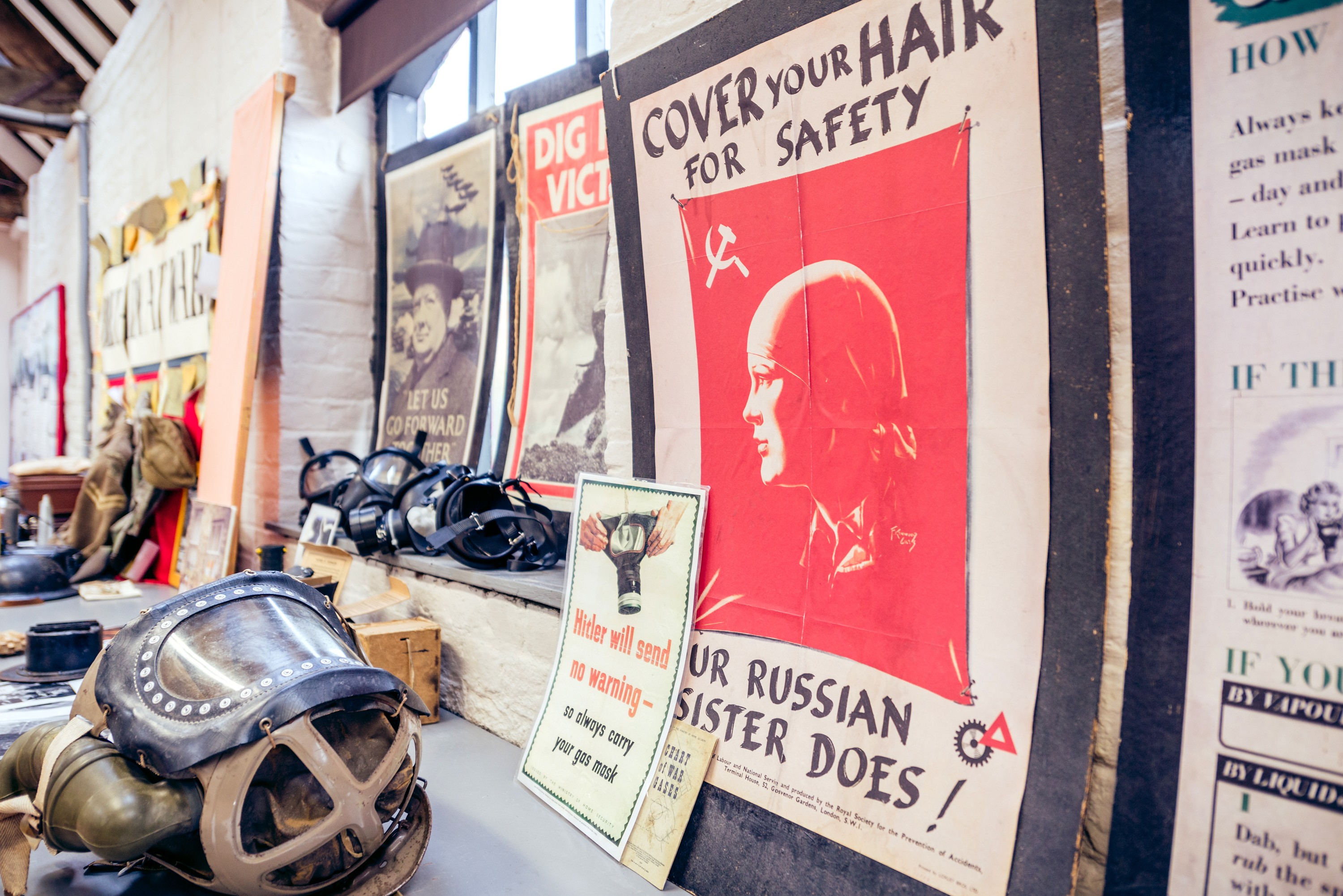 display of World War 2 gas masks and old posters