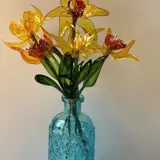resin yellow flowers in a glass vase