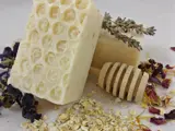 six handmade soaps on a table some with petals in