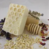 six handmade soaps on a table some with petals in