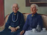 painting of 2 formally dressed ladies sitting on a sofa 