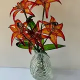 flowers that have been dipped in resin in a vase