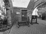 black and white image of old fashined stocks for criminals
