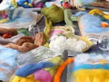 various colours of felt being used fir wet felting workshop place on a table