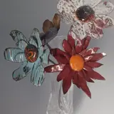 flowers made from copper and enamel in a vase